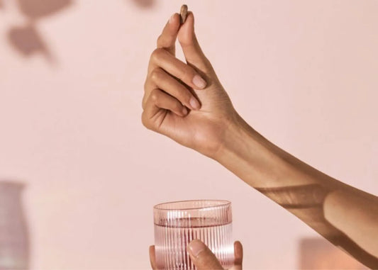 Daily multivitamins on a table with fresh fruits and vegetables